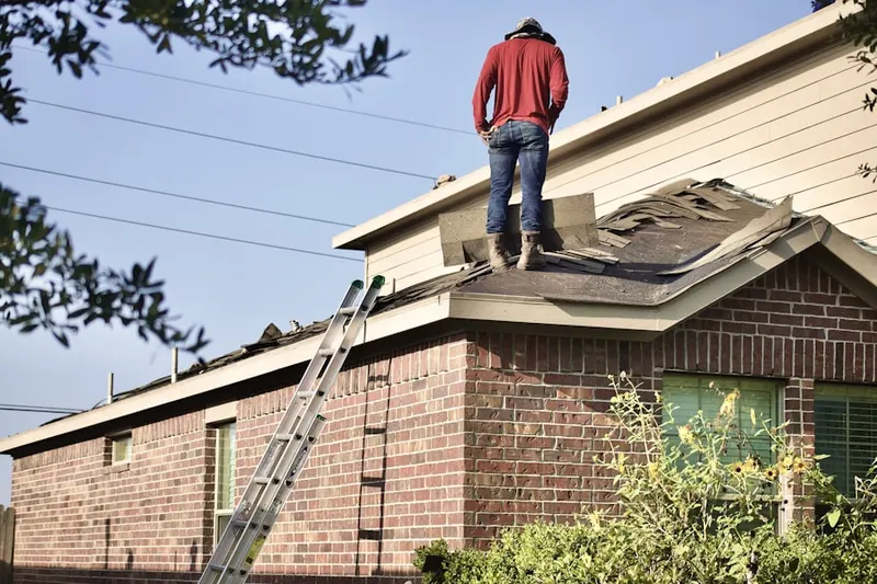Professional roofer working on a residential roof in Delran